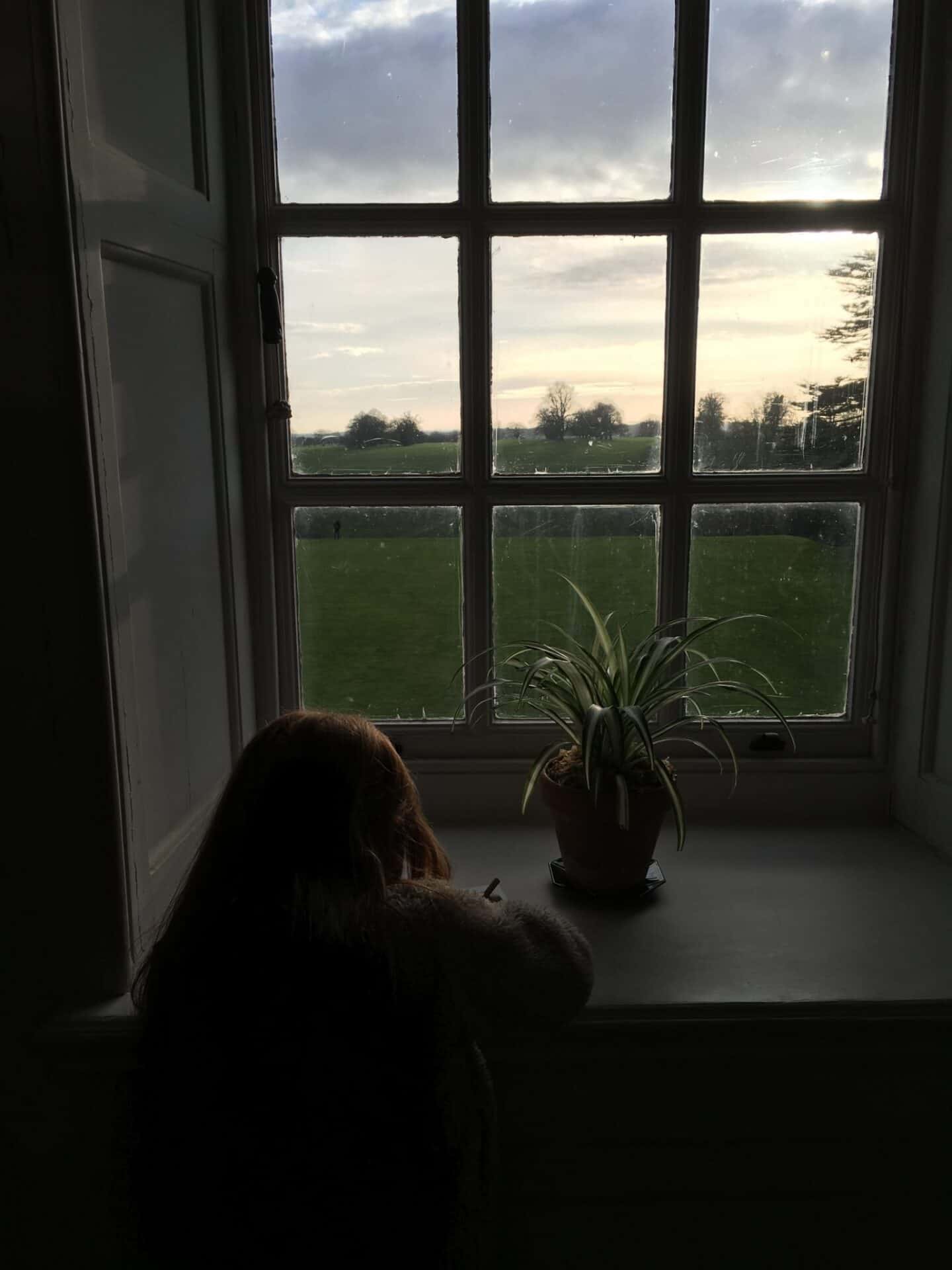 Ava looking out of the window at Upton House