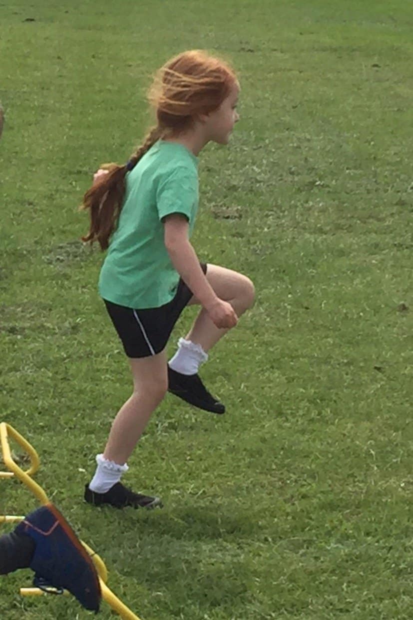 Ava doing the hurdles at Sports Day