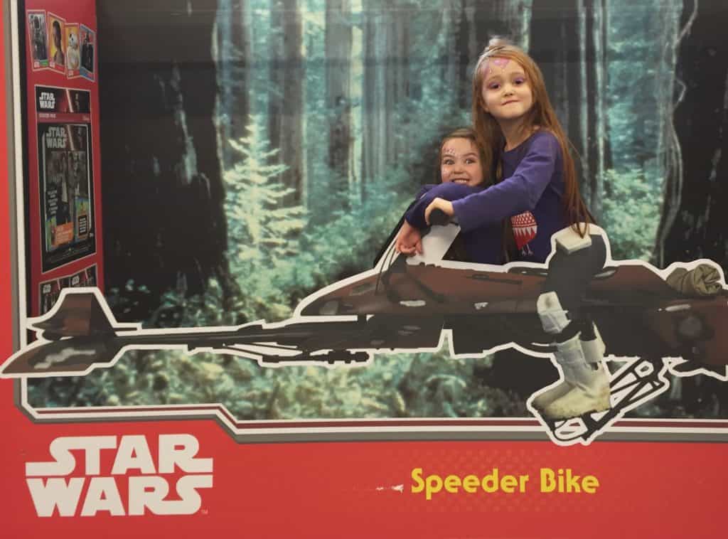 Ava and Thea on a Star Wars Speeder Bike