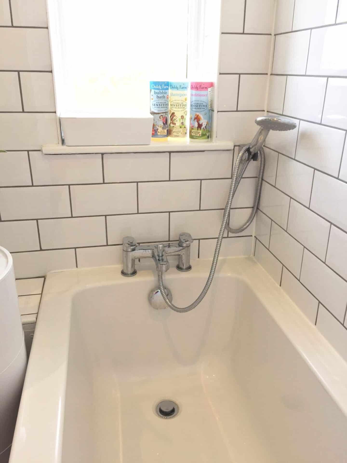 Bath with white metro tiles and grey grout