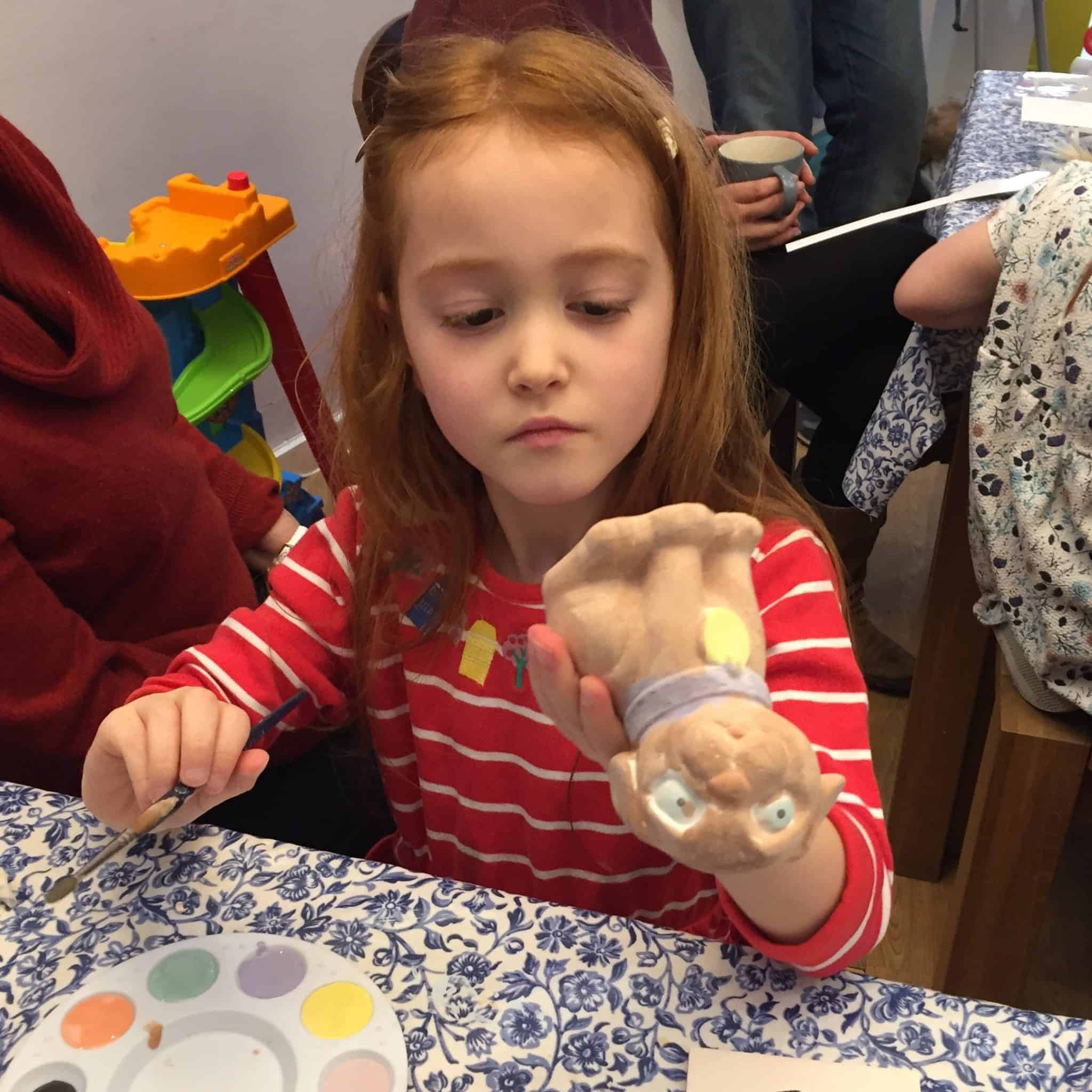 Ava painting her pottery
