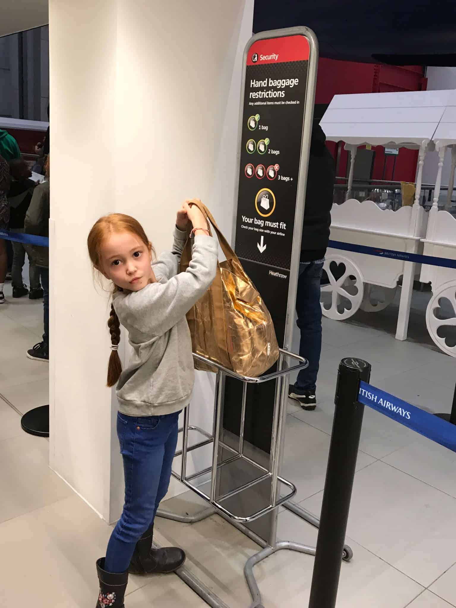 Checking if my bag fits into handluggage at Kidzania