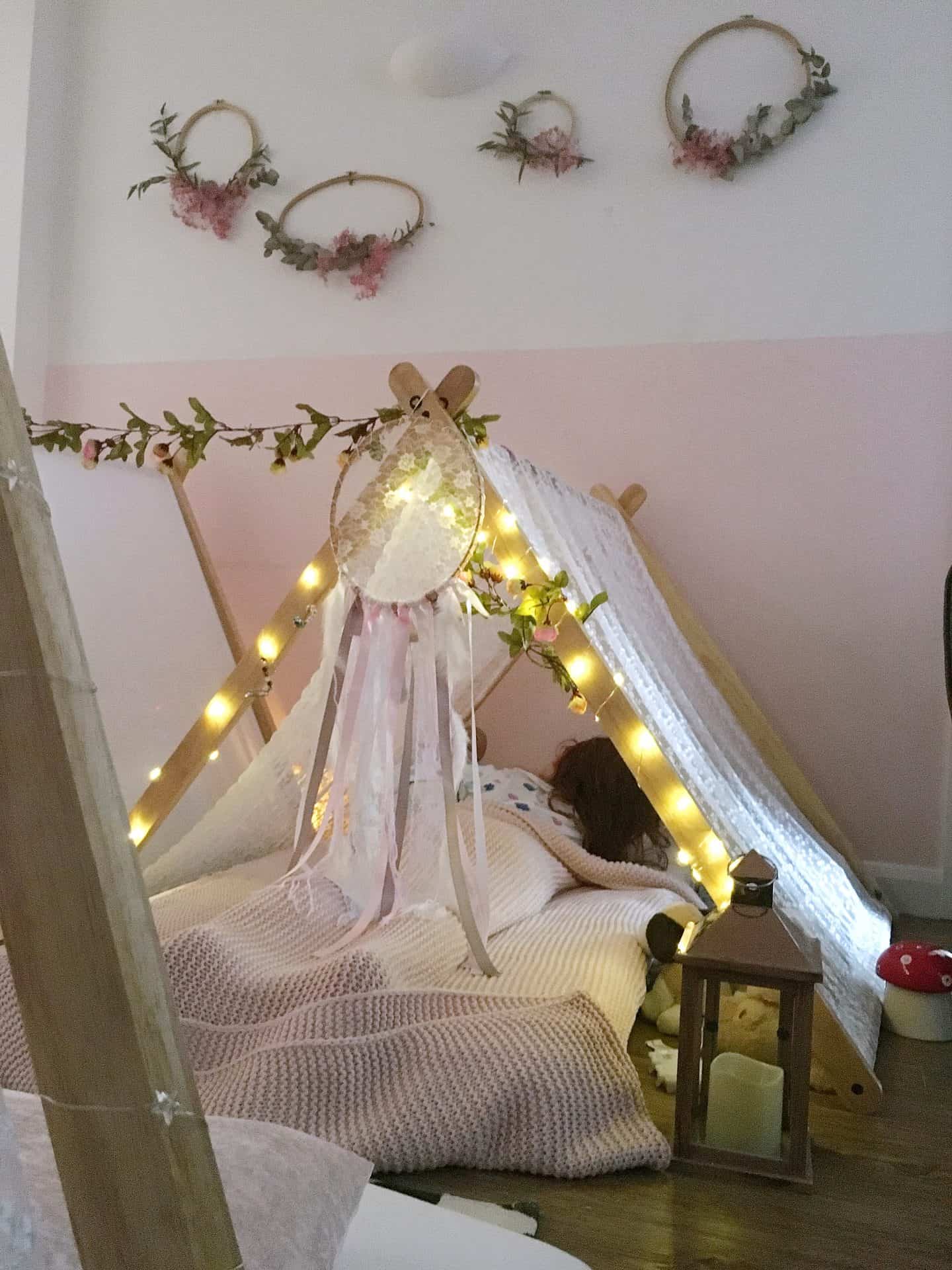Young girl sleeping in an indoor tent for a magical teepee sleepover parties