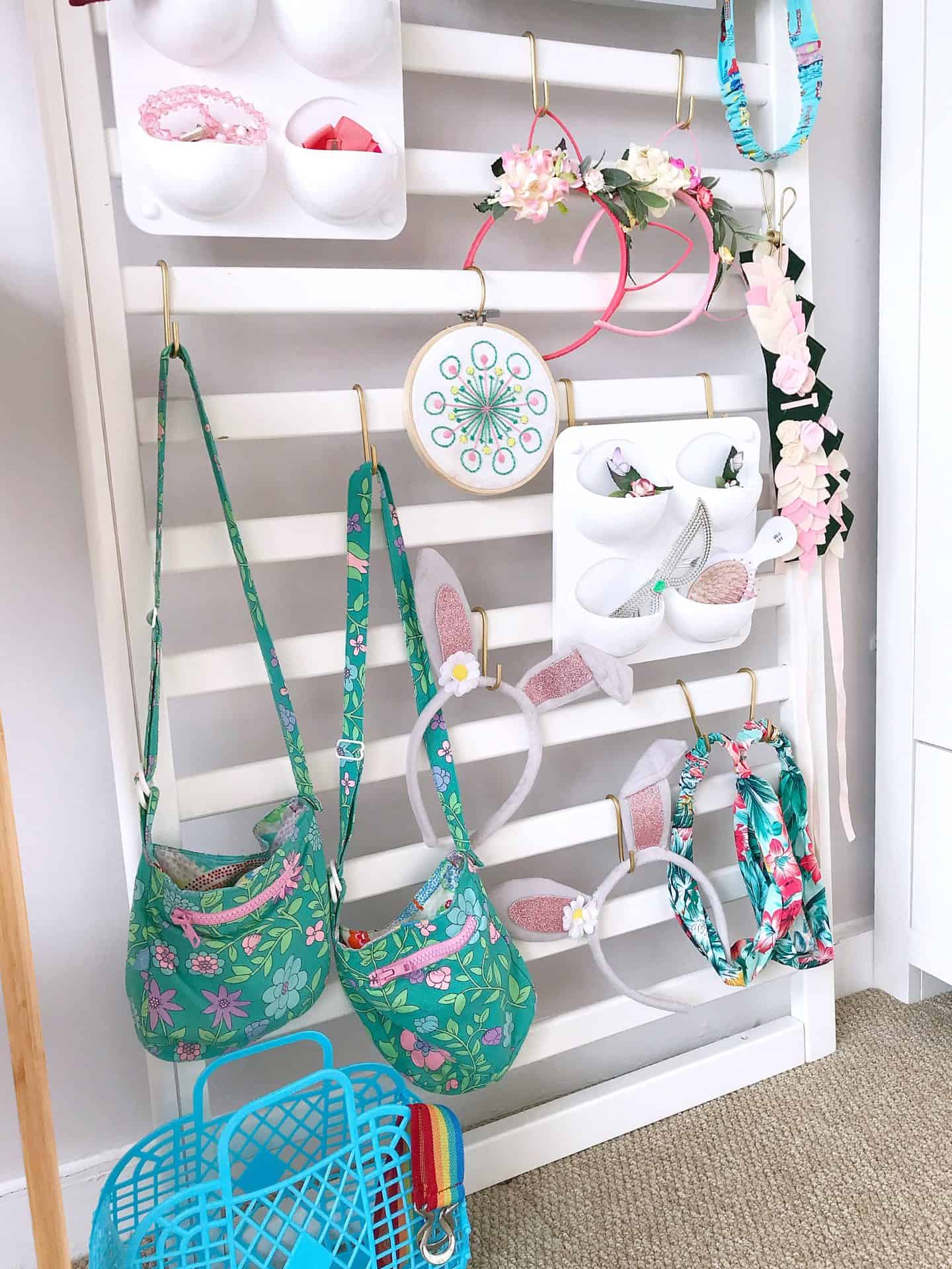White accessories organiser made from an old cot side and IKEA s hooks