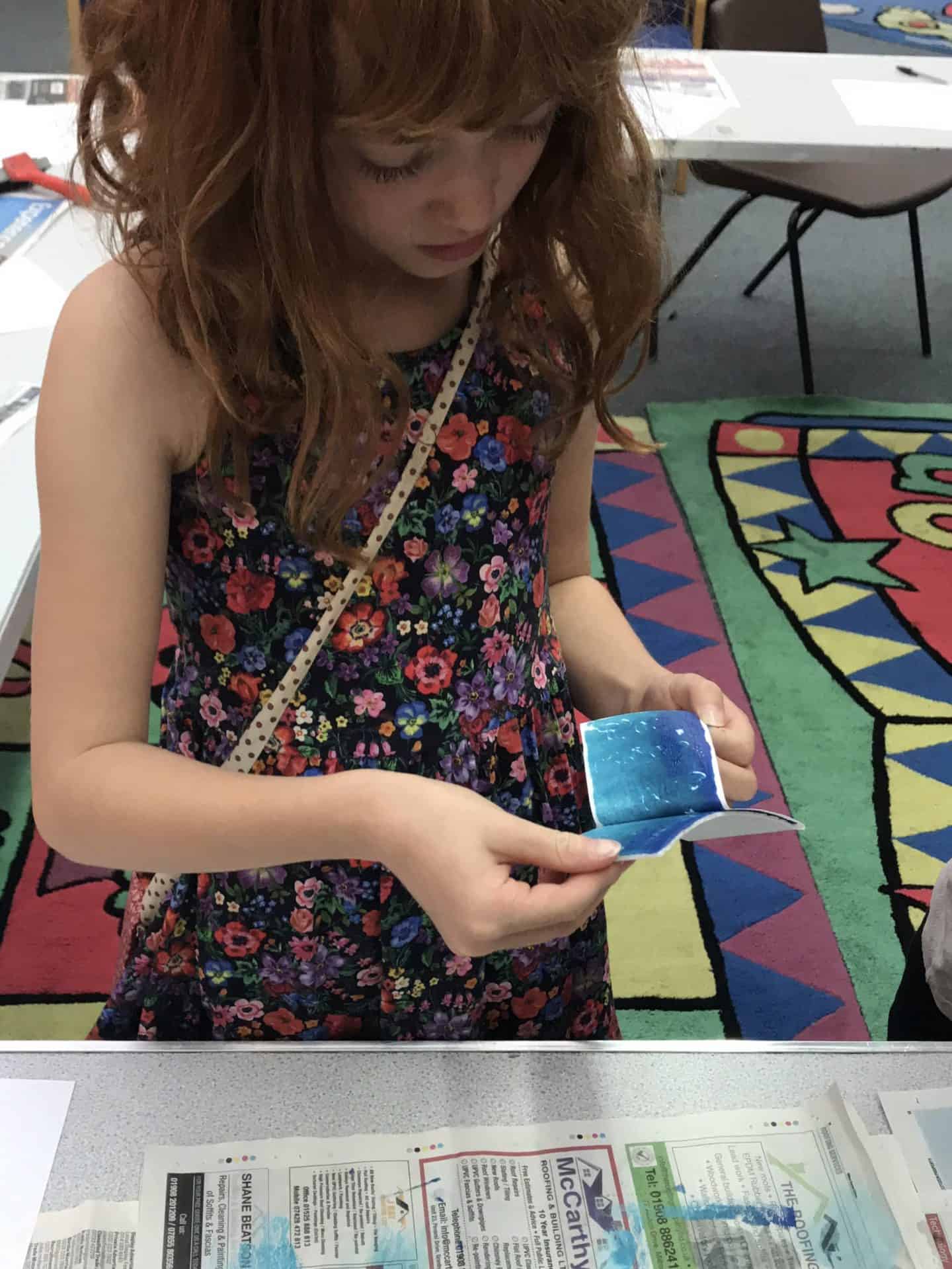 Peeling the paper away to see the print