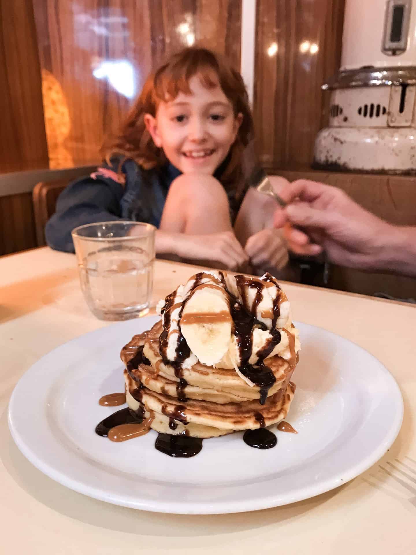 Enjoying-pancakes-at-The-Breakfast-Club-London