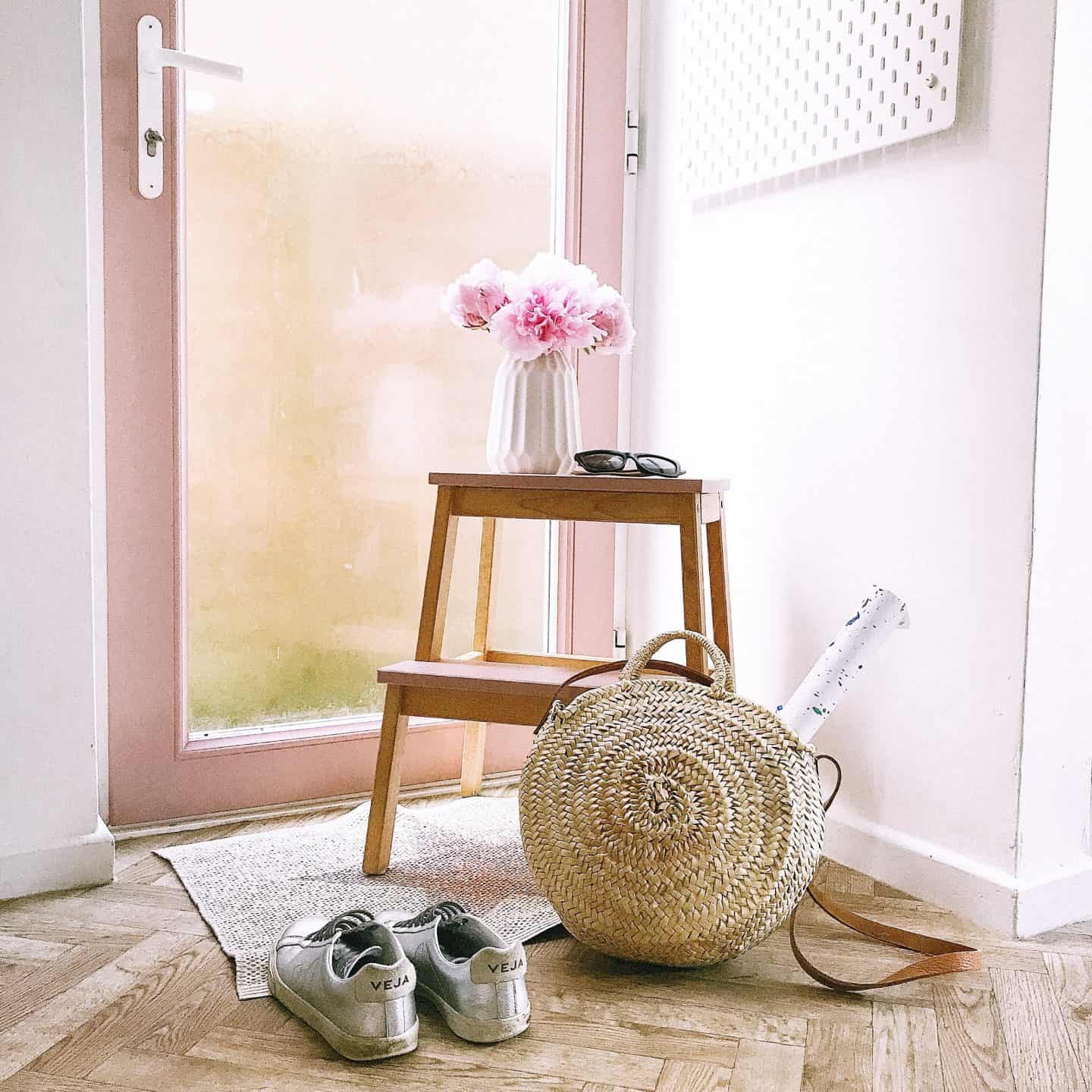 Glass uPVC door painted in Frenchic Dusky Blush Al Fresco paint with a wooden stool, trainers and bag in front. 