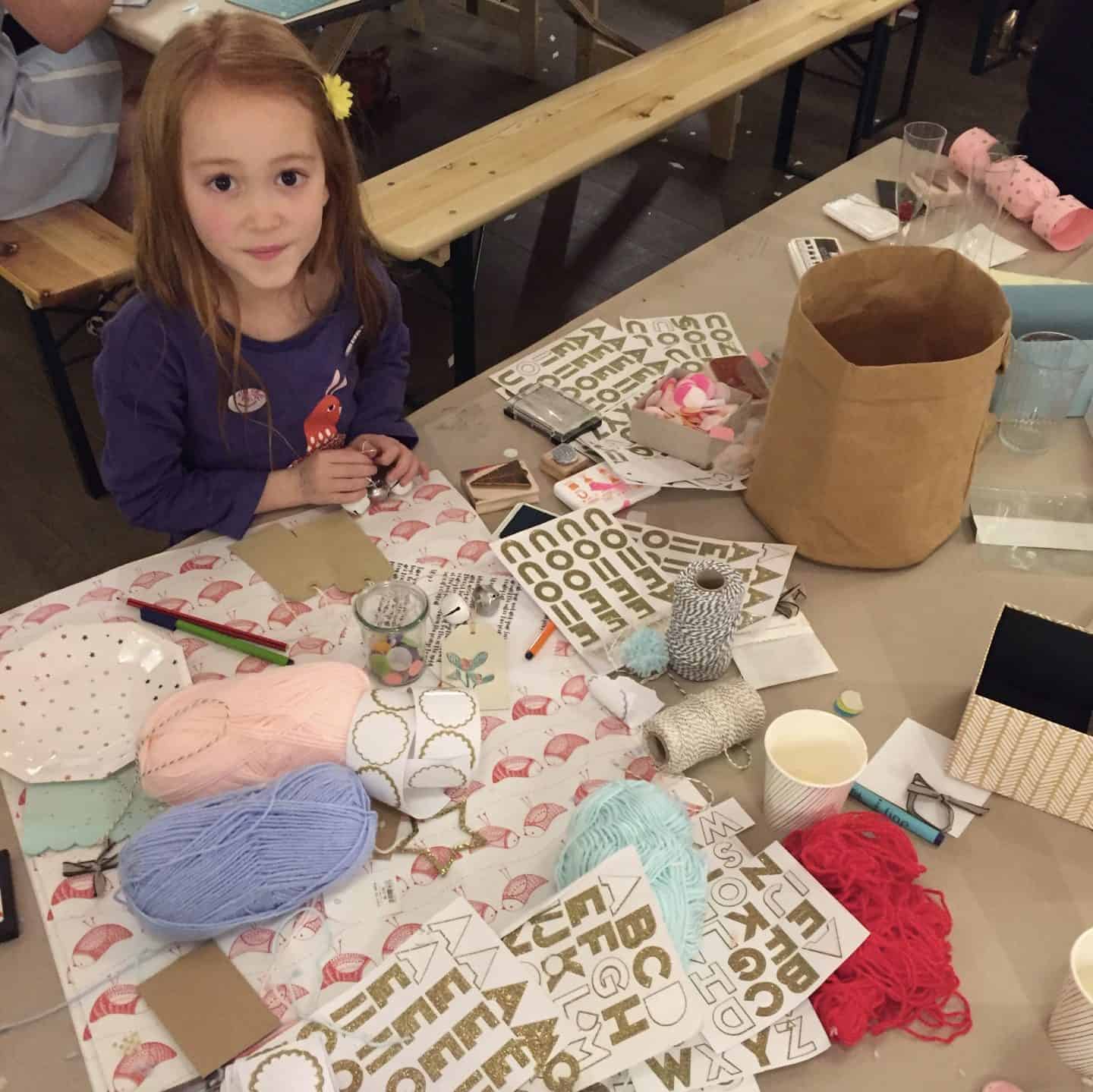 A girl making home made Christmas present tags