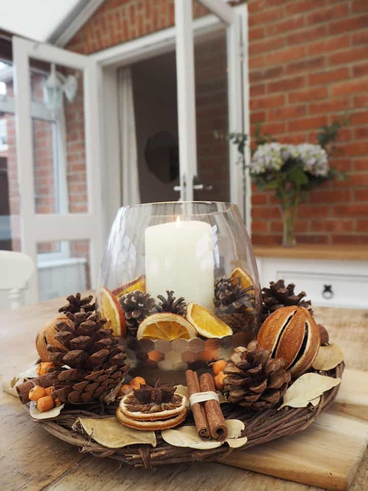 Christmas table centrepiece with dried oranges and cinnamon