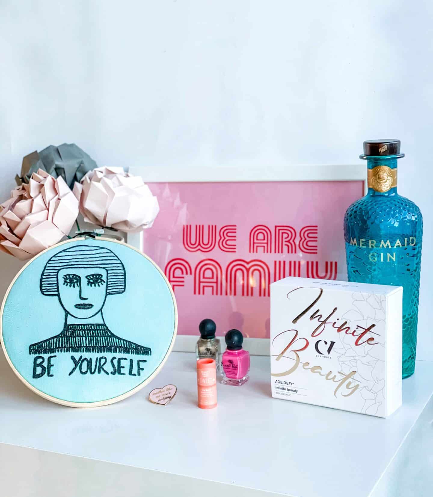 Mother's day gift ideas for eco-conscious mums, including origami flowers, 12-free mail enamel, a We are Family print, organic skincare and sustainable gin 