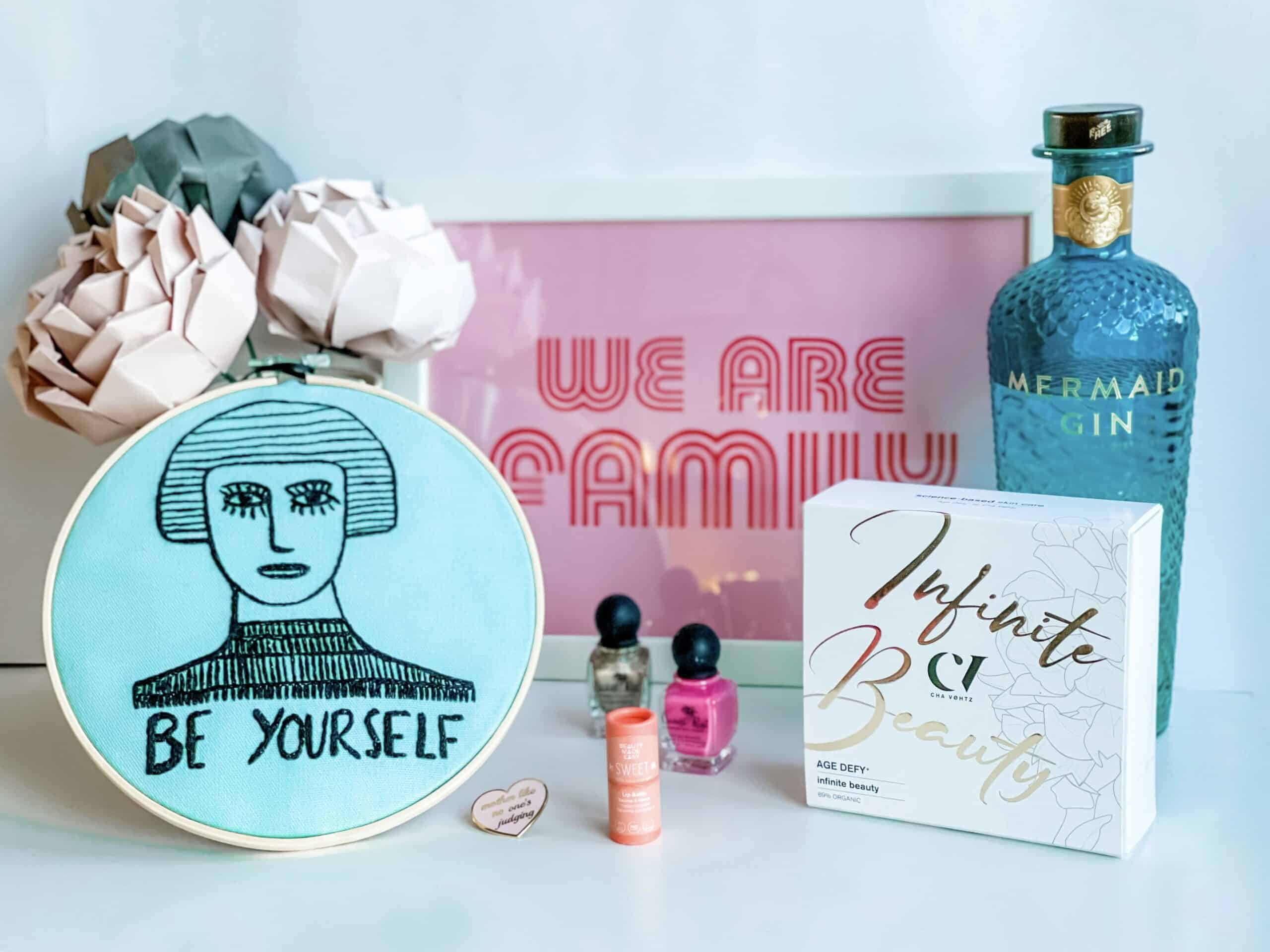 Mother's day gift ideas for eco-conscious mums, including origami flowers, 12-free mail enamel, a We are Family print, organic skincare and sustainable gin