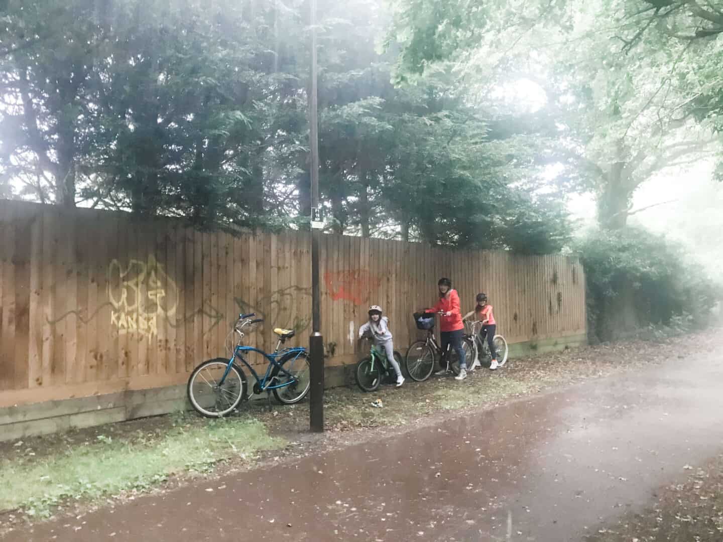 A family biking in the rain