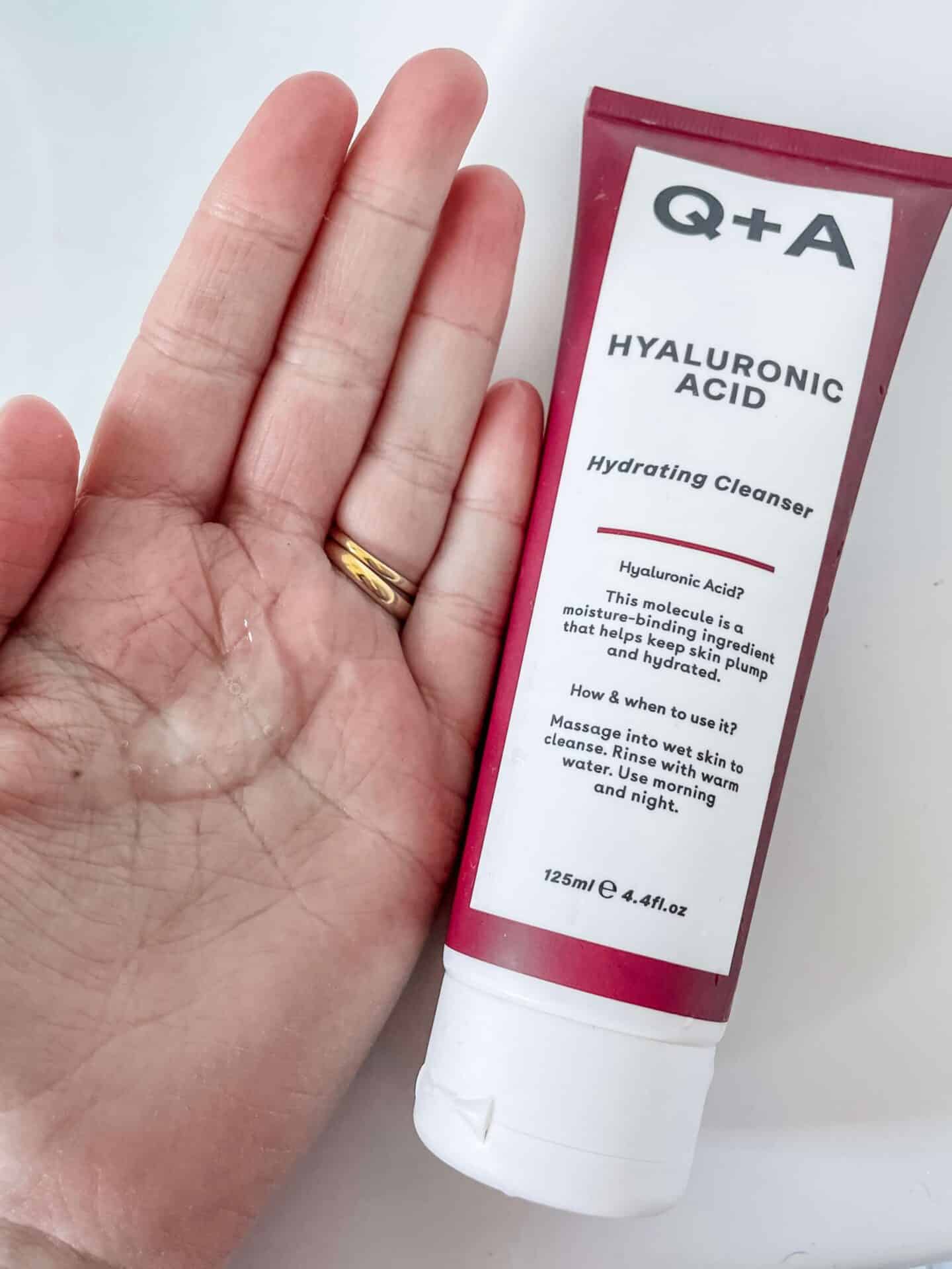 A blob of Q+A Hyaluronic Acid Hydrating Cleanser on a hand
