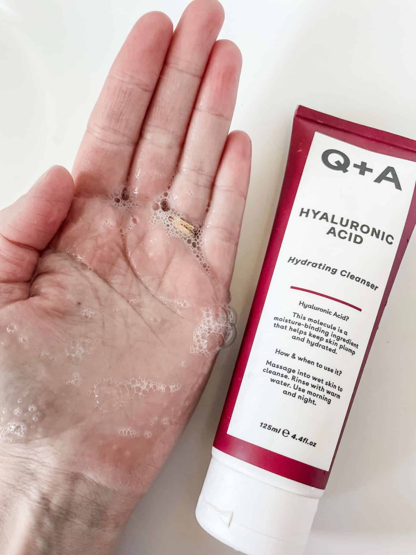 A foaming blob of Q+A Hyaluronic Acid Hydrating Gel Cleanser on a hand