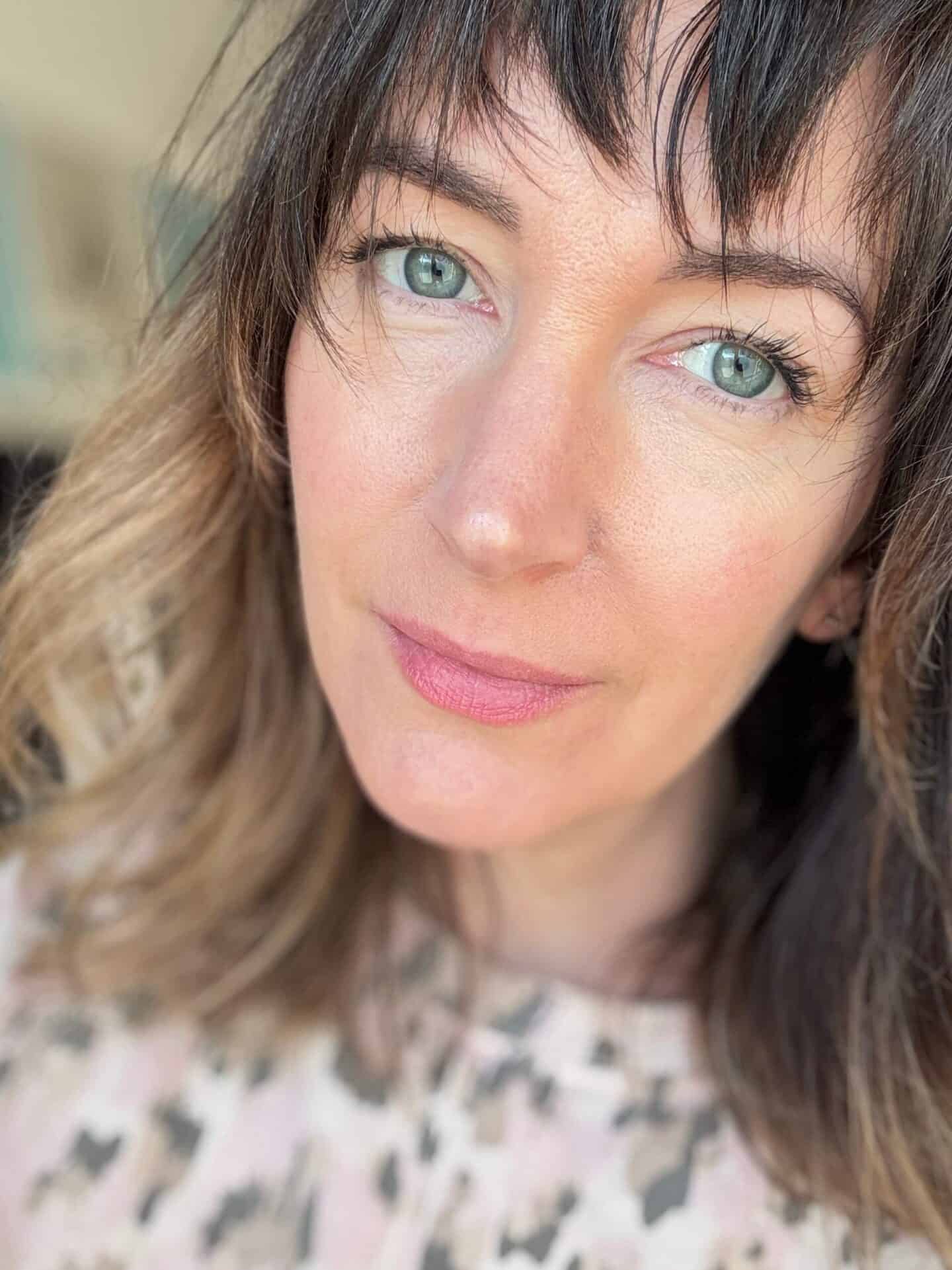 A white woman wearing Husk & Seed Natural Mineral Sunscreen SPF30 beneath make-up in the evening