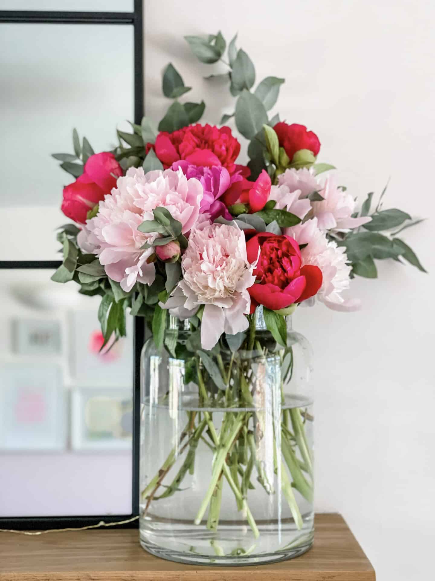 Peonies and eucalyptus in a glass vase